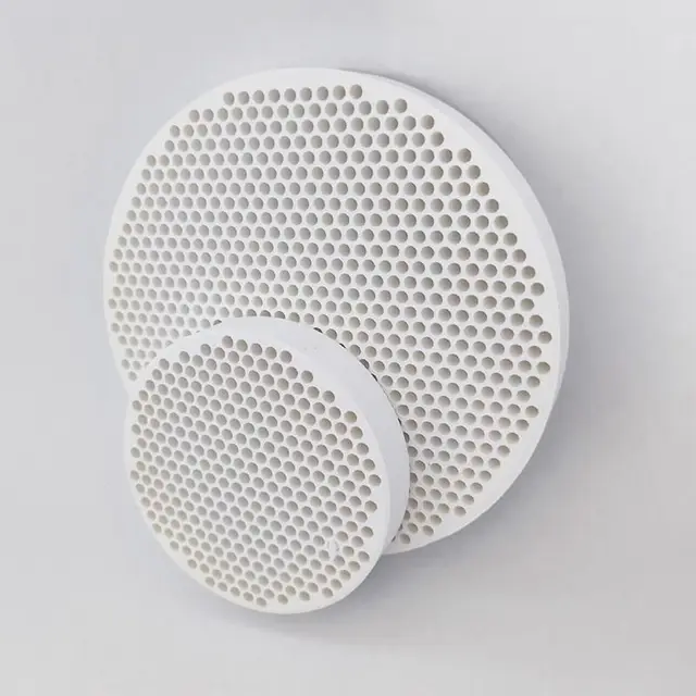 Ceramic foundry filter held up so its open-cell porosity is visible