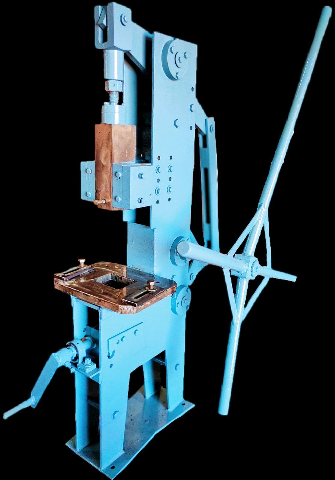 A Kavan manual toggle press: iron frame, counterweighted lever arm and the die table that forms clay diyas.